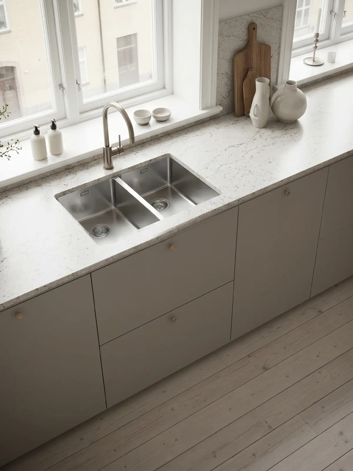 Närbild på kök i Off Grey med släta köksluckor i Pure, integrerad ugn och ljus stenbänkskiva.